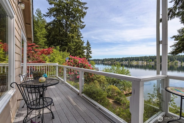 wooden deck featuring a water view