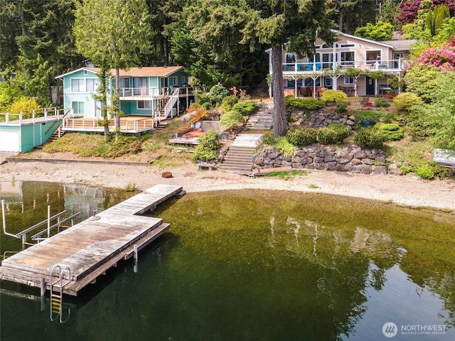 dock area featuring stairs and a water view
