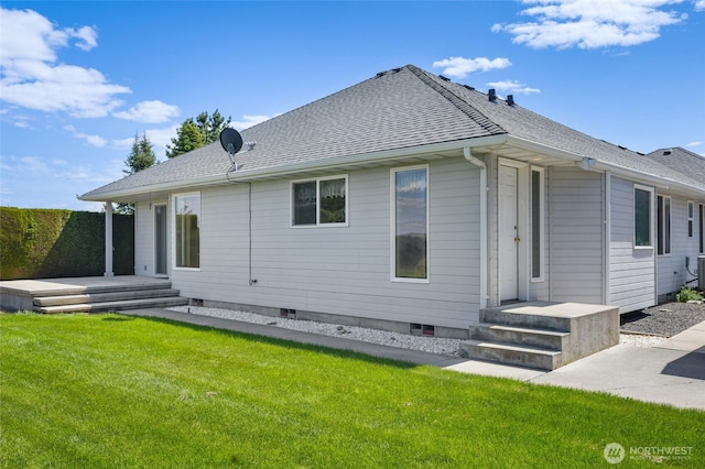 rear view of property with a yard