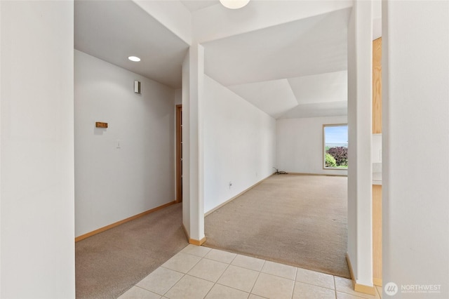 additional living space with lofted ceiling, recessed lighting, baseboards, light tile patterned floors, and light carpet