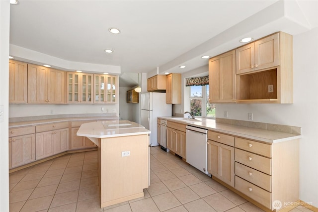 kitchen featuring white appliances, light brown cabinetry, recessed lighting, and a sink