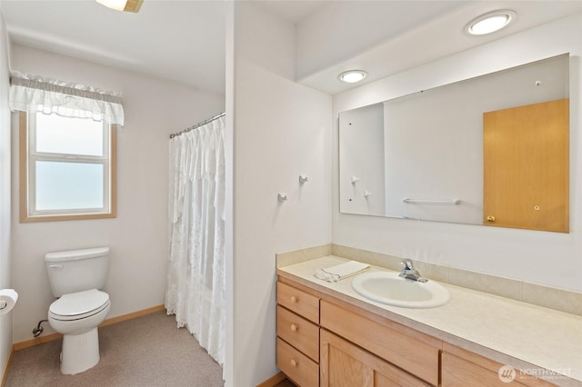 full bathroom featuring toilet, baseboards, vanity, and curtained shower