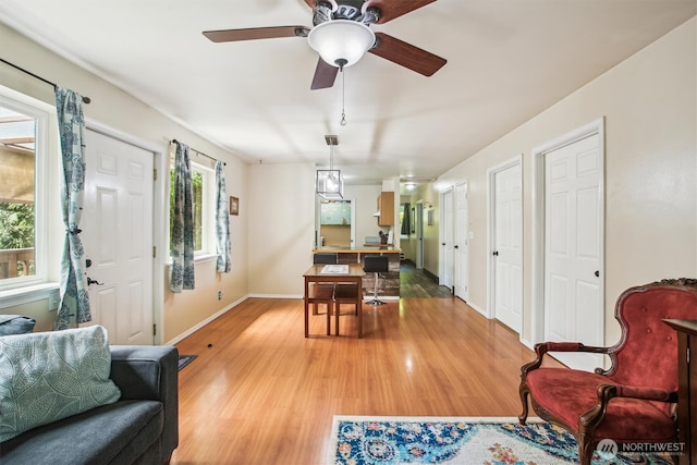 5772 NE Spruce Dr, Hansville, WA 98340 - dining area with light wood-style floors, baseboards, and a ceiling fan