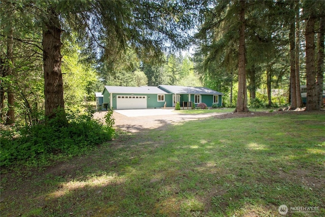 single story home featuring driveway, an attached garage, and a front yard