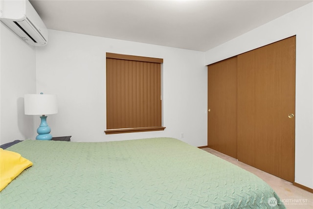 bedroom with a wall mounted air conditioner and light colored carpet