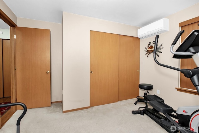 workout area with a wall mounted AC and light carpet