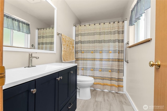 bathroom with wood finished floors, toilet, vanity, and a shower with shower curtain