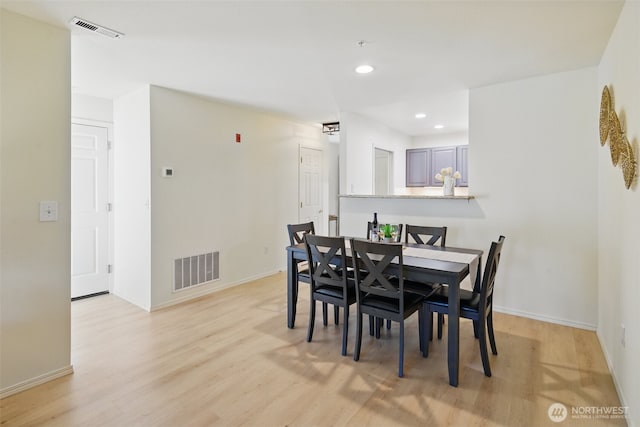 dining area featuring baseboards, light wood-type flooring, visible vents, and recessed lighting