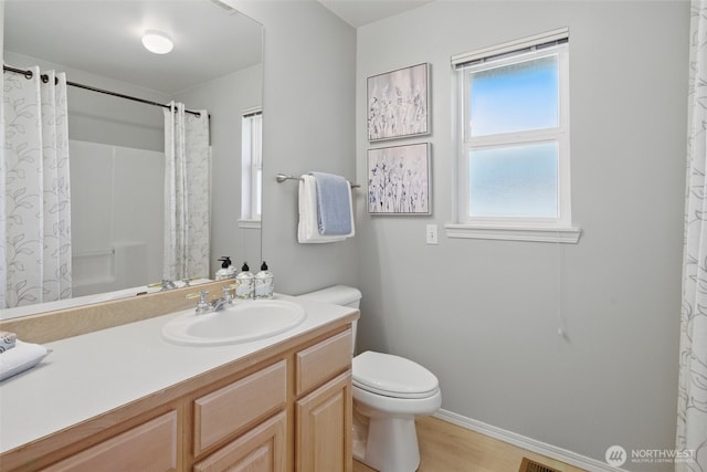 bathroom featuring toilet, wood finished floors, vanity, curtained shower, and baseboards
