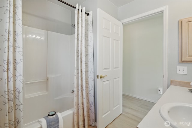 bathroom featuring vanity, shower / bath combination with curtain, and wood finished floors