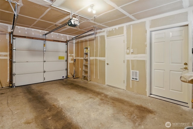 garage with visible vents and a garage door opener