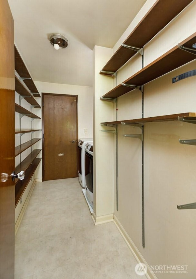 washroom featuring laundry area and separate washer and dryer