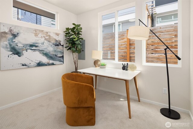 carpeted home office featuring baseboards and electric panel