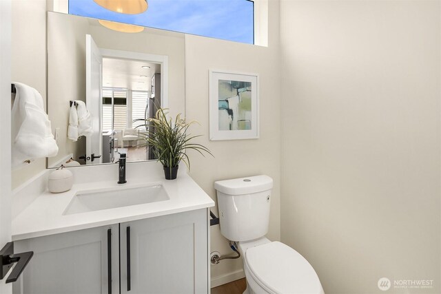 half bathroom with toilet and vanity