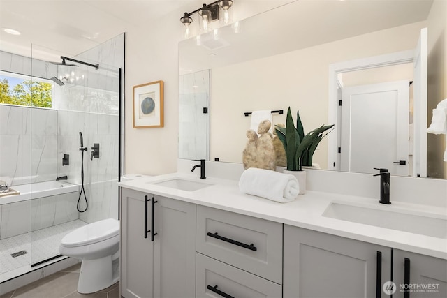 bathroom with a shower with shower door, toilet, and double vanity