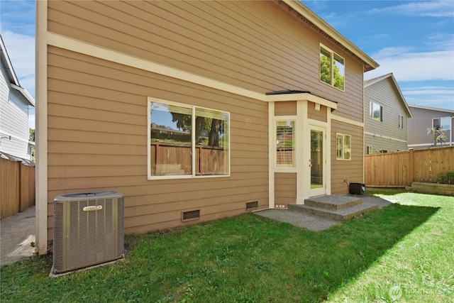 rear view of property featuring central AC and crawl space