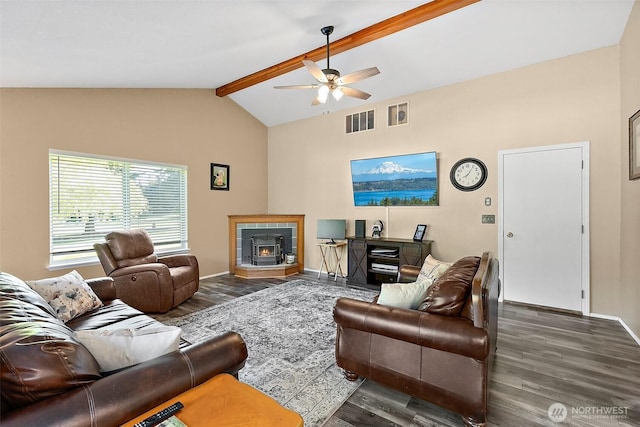 living room featuring beam ceiling, ceiling fan, wood finished floors, baseboards, and a fireplace