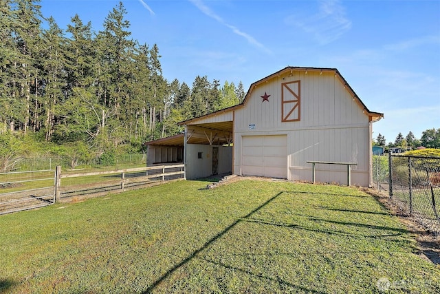 view of barn with an exterior structure and driveway