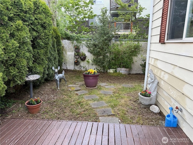 view of yard with a wooden deck and fence