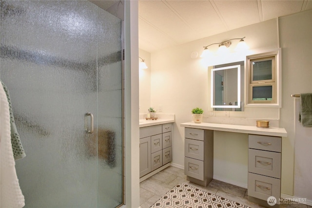 full bathroom featuring vanity, tile patterned flooring, and a stall shower
