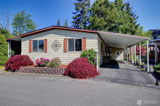 manufactured / mobile home featuring driveway and a carport