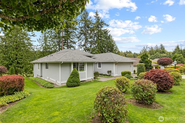 view of side of home with a garage, a yard, and roof with shingles