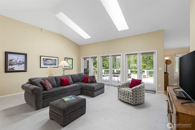 living room featuring a skylight, light carpet, baseboards, french doors, and high vaulted ceiling