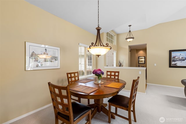 carpeted dining area featuring baseboards