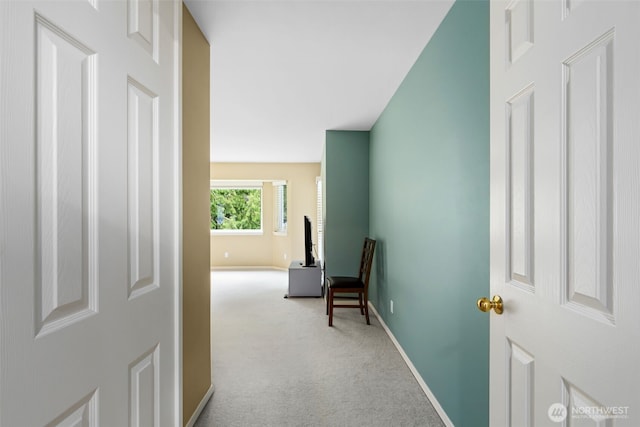 corridor featuring carpet flooring and baseboards