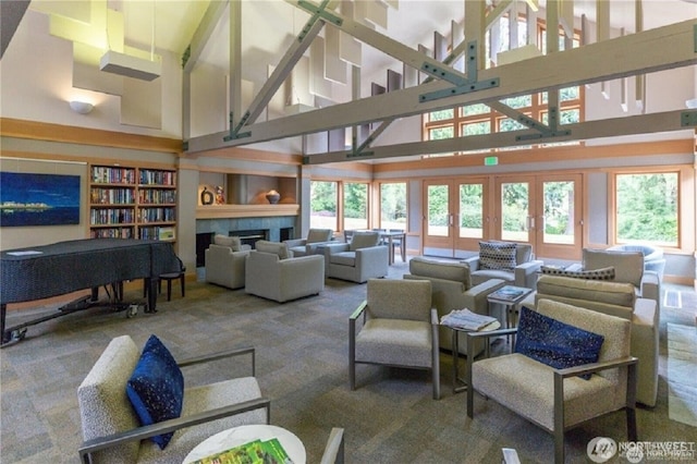 carpeted living area featuring high vaulted ceiling and a tiled fireplace