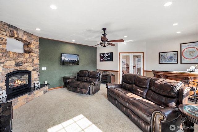 living area with recessed lighting, carpet, a fireplace, a ceiling fan, and french doors