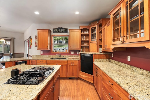 kitchen with black appliances, a sink, light stone counters, open shelves, and recessed lighting