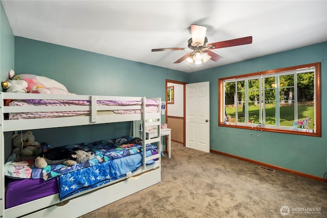carpeted bedroom featuring baseboards and ceiling fan