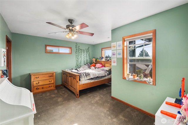 bedroom with multiple windows, carpet flooring, baseboards, and ceiling fan