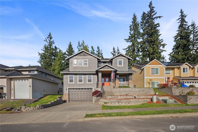 craftsman-style home with concrete driveway, an attached garage, and a residential view