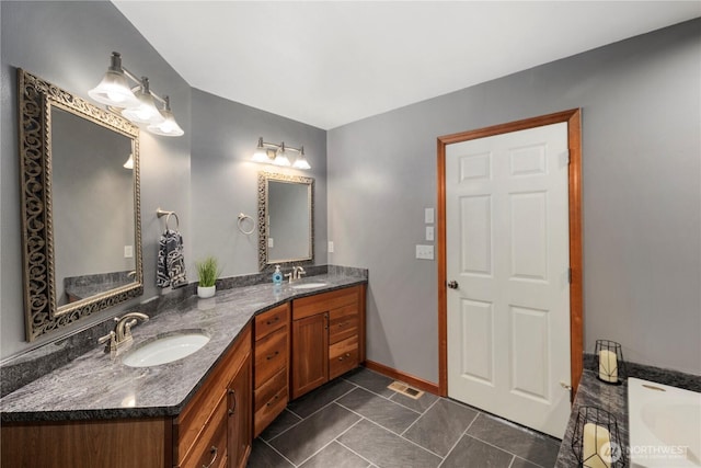 full bath featuring double vanity and tile patterned flooring