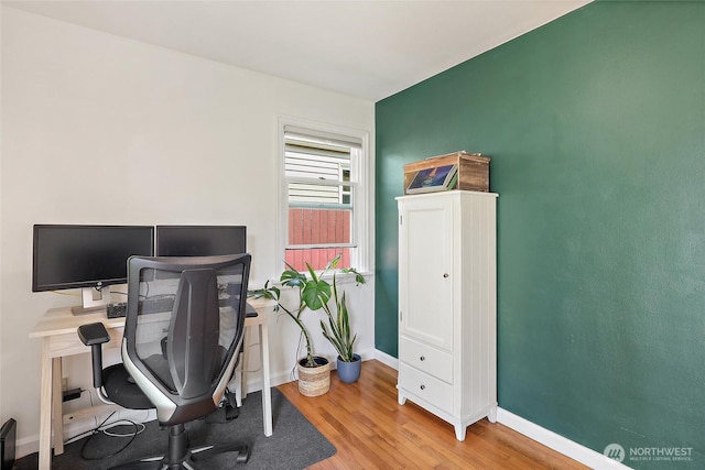 home office featuring baseboards and wood finished floors