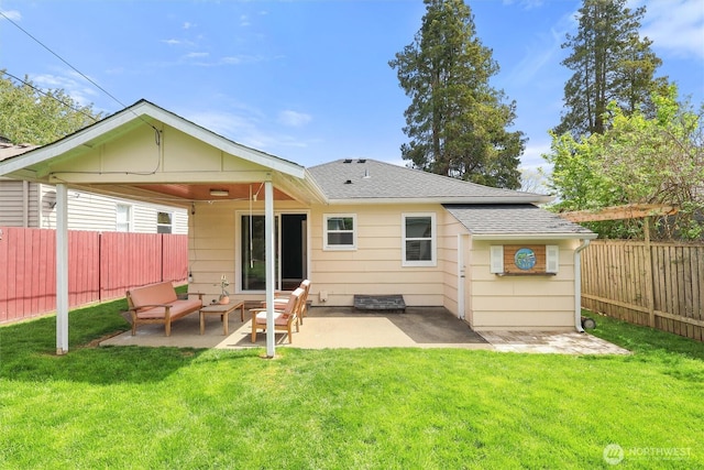 back of property featuring a fenced backyard, a shingled roof, a patio, and a lawn