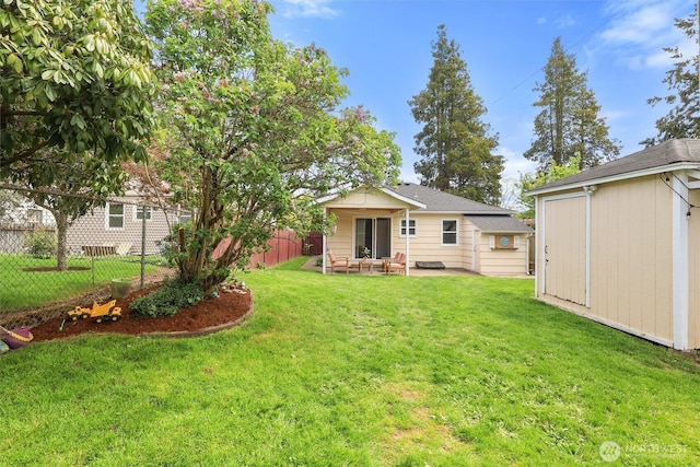 back of property featuring a storage shed, a patio, an outbuilding, fence, and a yard