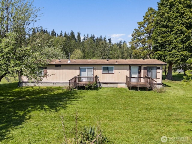 rear view of house featuring a yard, crawl space, and a wooden deck