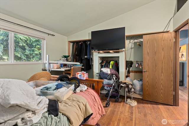 bedroom featuring lofted ceiling and wood finished floors