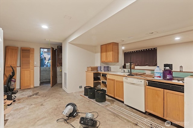 kitchen with white dishwasher, a sink, concrete floors, recessed lighting, and light countertops