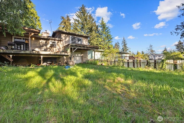 view of yard with a garage and fence
