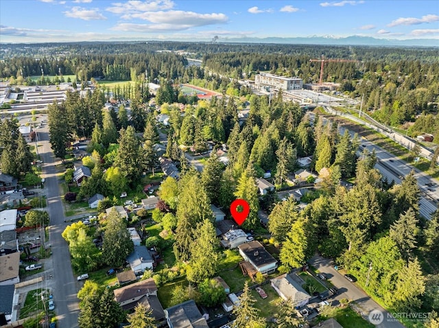 aerial overview of property's location with a heavily wooded area