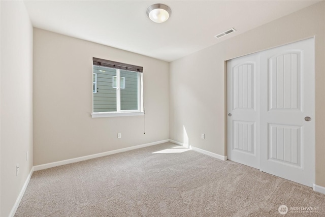 1517 Onyx St SE, Olympia, WA 98501 - unfurnished bedroom with baseboards, carpet flooring, a closet, and visible vents