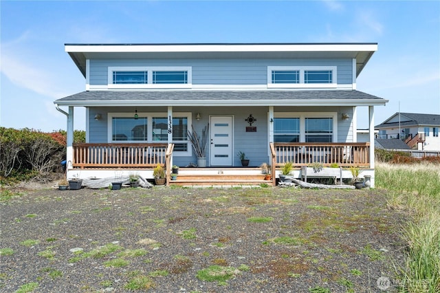 view of front of house with a porch and roof with shingles