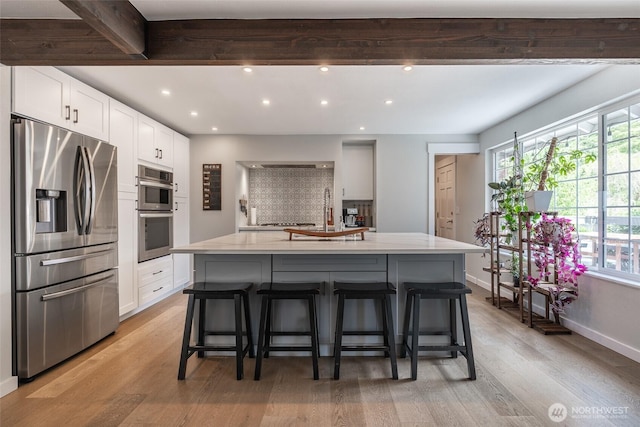 2656 168th Ave NE, Bellevue, WA 98008 - kitchen with appliances with stainless steel finishes, recessed lighting, light wood-type flooring, healthy amount of natural light, and white cabinetry