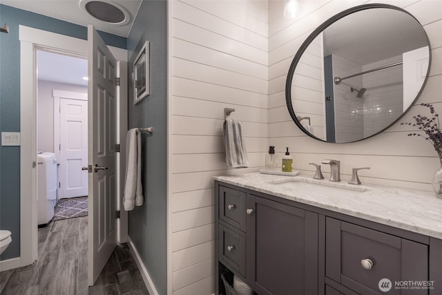 2656 168th Ave NE, Bellevue, WA 98008 - bathroom featuring vanity, baseboards, wood finished floors, washer / clothes dryer, and toilet