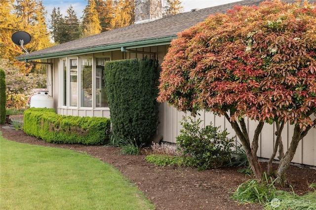 524 Carl Way, Aberdeen, WA 98520 - view of property exterior with board and batten siding, a chimney, roof with shingles, and a yard