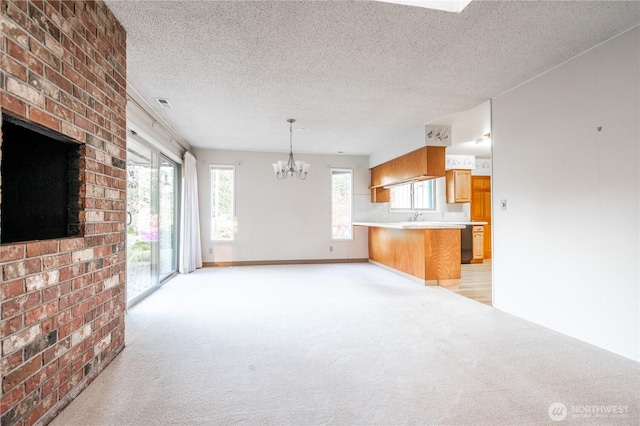 524 Carl Way, Aberdeen, WA 98520 - unfurnished living room with a chandelier, light carpet, a textured ceiling, a sink, and baseboards